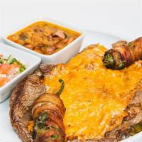 El Torito / · Un filete delgado, dos nopales cubiertos con queso y dos jalapeños rellenos de queso y se en...