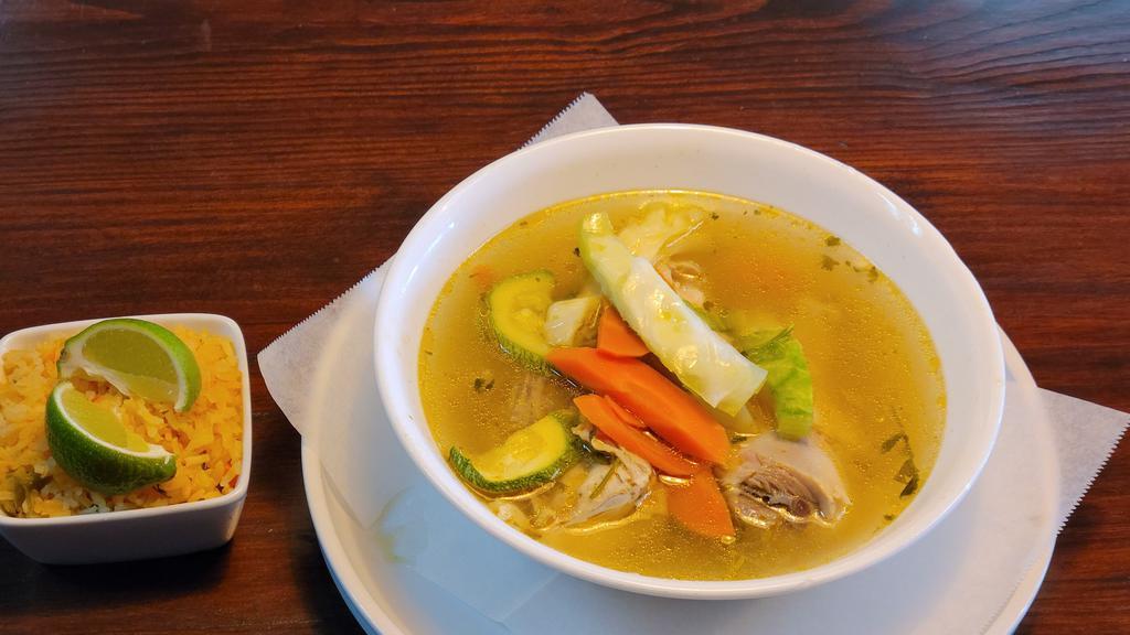 Caldo De Pollo / Chicken Soup · Sopa de pollo con verduras servidas con arroz. / Chicken soup with vegetables served with rice.