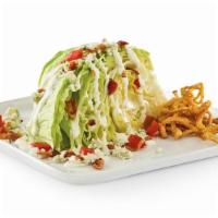 Classic Wedge Salad · Bleu cheese and bacon crumbles, crispy onion straws, diced tomatoes, and ranch. 420 cal.