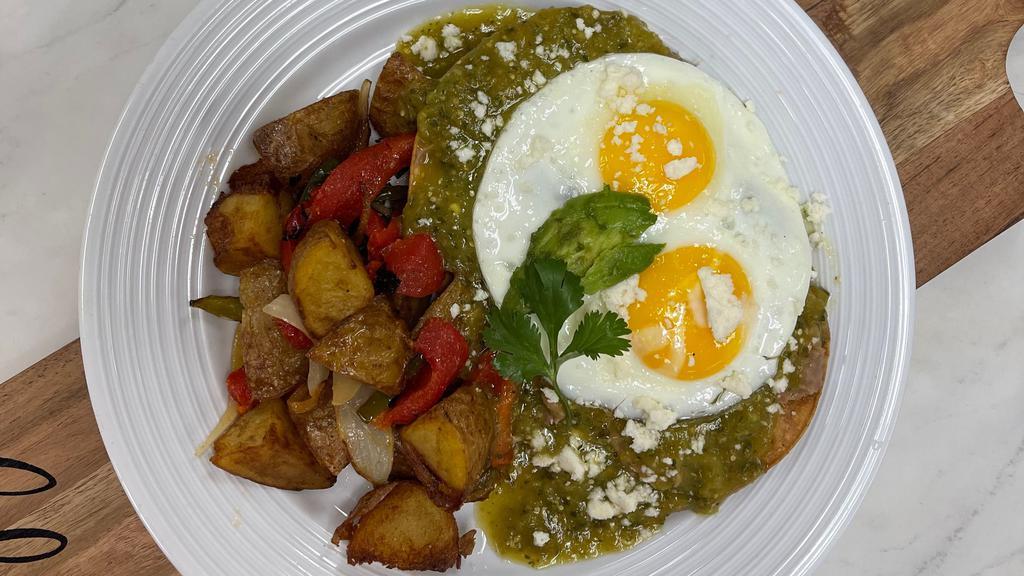Huevos Rancheros · Two tortillas, housemade green salsa, two eggs, cotija cheese, avocado and served with home fries.