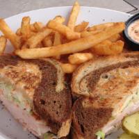 Turkey Reuben · Fresh roasted turkey served on grilled marble rye with swiss cheese and coleslaw. Served wit...