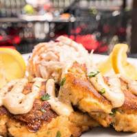 Chesapeake Jumbo Lump Crab Cakes · Two jumbo lump crab cakes lightly dusted and drizzled with our crab sauce, served with cole ...