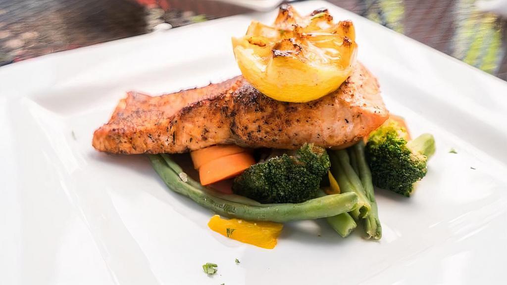 Blackened Salmon Filet · Grilled salmon filet with a light coating of blackened redfish seasoning. Served with our steamed vegetables and side salad.