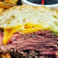 The Prime Rib Dip · Hand sliced prime Angus rib meat, melted cheddar and jack cheeses, caramelized onions and au...
