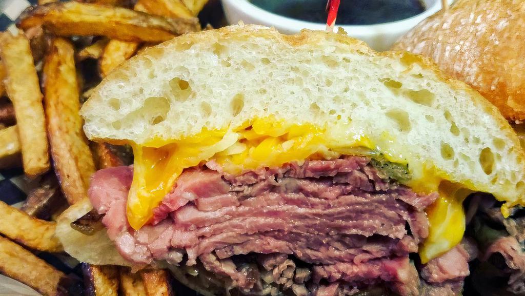The Prime Rib Dip · Hand sliced prime Angus rib meat, melted cheddar and jack cheeses, caramelized onions and au jus.....Say no more.