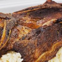 Chuletas Fritas / Pork Chops · Comes with white rice and beans.