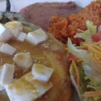 Chile Relleno  · Beef or chicken top with salsa ranchera and monterrey cheese with rice beans salad and two t...