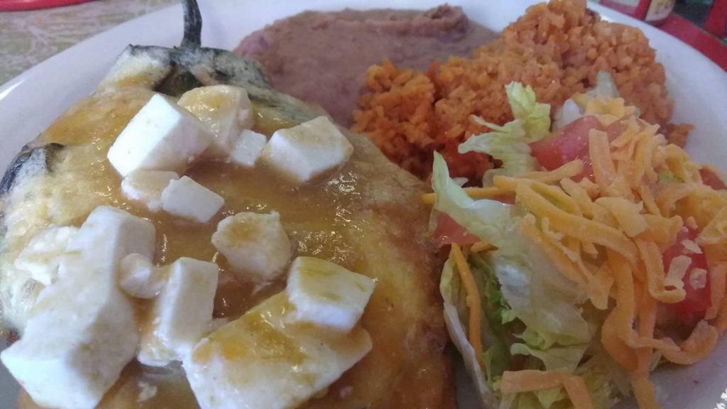 Chile Relleno  · Beef or chicken top with salsa ranchera and monterrey cheese with rice beans salad and two tortillas