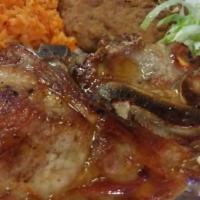 Pork Chop Plate  · Pork chop with rice, beans, salad and avocato with two tortillas