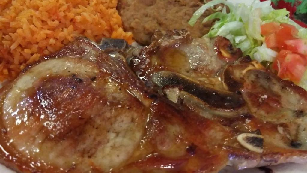 Pork Chop Plate  · Pork chop with rice, beans, salad and avocato with two tortillas