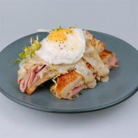 Croque Madame · ham, gruyere, sausage gravy, sunny egg*, dijon frisée salad