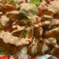 Cubano Tostones · Fried plantains, pulled pork, lettuce, onion, tomatoes, topped with mayo/ketchup sauce.