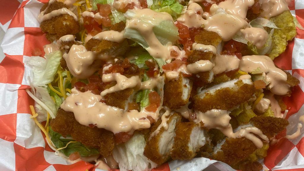 Cubano Tostones · Fried plantains, pulled pork, lettuce, onion, tomatoes, topped with mayo/ketchup sauce.