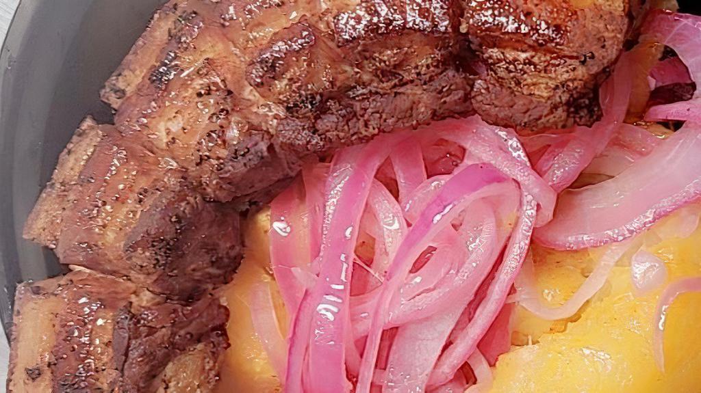 Chicharone And Yuca · Deep fried crispy pork served with yuca & onions smothered over it