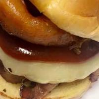 The Rodeo · With bacon, Onions rings and drizzled with BBQ sauce