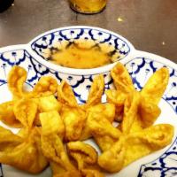 Crab Rangoon (5) · Cream cheese and crab in crispy wonton with sweet and sour sauce.