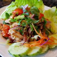 Yum Thai Salad · Grilled lemongrass chicken  with lime juice, cucumber, lettuce, onions, tomatoes and cilantro.