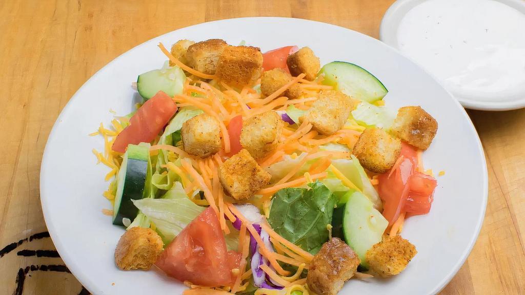 Dinner Salad · Your choice of dressing served on the side, iceberg lettuce, cucumbers, tomatoes, cheese, and croutons.