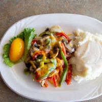 Smothered Chicken Breast · Our marinated chicken breast topped with sautéed onions, red and green peppers, fresh mushro...