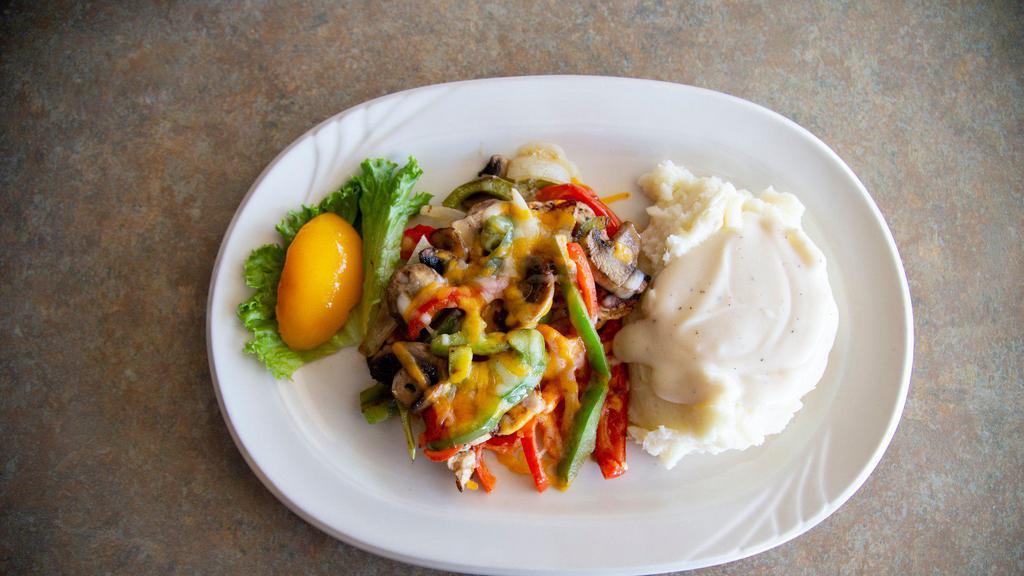 Smothered Chicken Breast · Our marinated chicken breast topped with sautéed onions, red and green peppers, fresh mushrooms and melted cheddar and Monterey jack cheese.