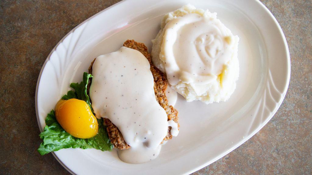 Pork Cutlet · A port tenderloin lightly breaded, deep fried and topped with our delicious country gravy.