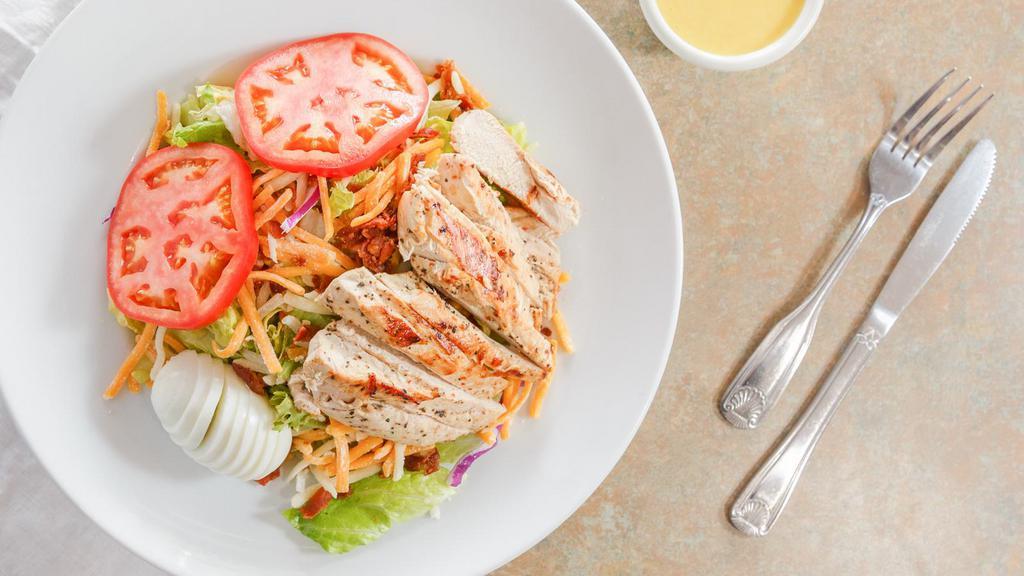 Grilled Chicken Salad · Our marinated grilled chicken breast, with a hard boiled egg, shredded jack and cheddar cheese on a generous bed of greens. Served with choice of salad dressing.