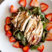 Spinach Salad · A pile of fresh spinach, tomato, egg, bacon, topped with bleu cheese crumbles and fresh stra...