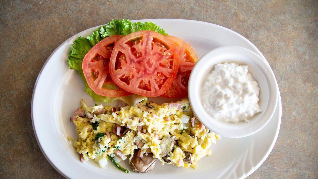 Low Carb Breakfast · 3 scrambled eggs with ham, spinach, mushrooms & onions, served with sliced tomatoes and cottage cheese.