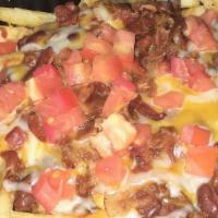 Chili Cheese Fries · A mountain of French fries topped with melted cheese, homemade chili, sour cream, diced toma...