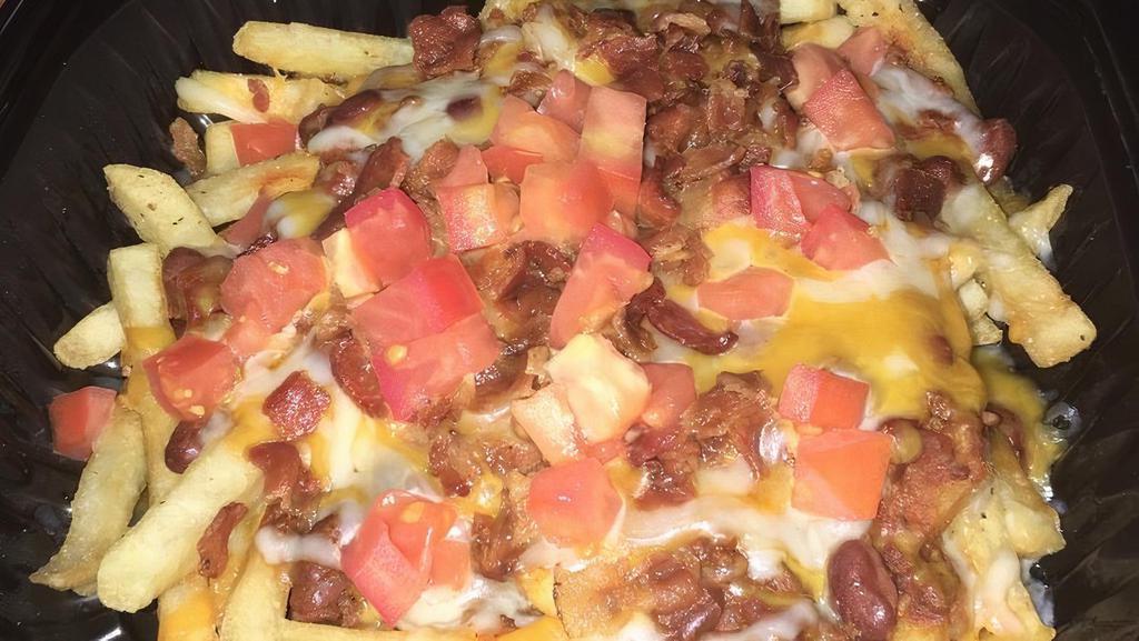 Chili Cheese Fries · A mountain of French fries topped with melted cheese, homemade chili, sour cream, diced tomatoes, and real bacon pieces.