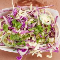 Homemade Spicy Slaw · Made-to-order cabbage blend with jalapeños and cilantro tossed in secret sauce.