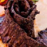 Tiras De Asado · Grilled beefshort ribs with chimichurri.
