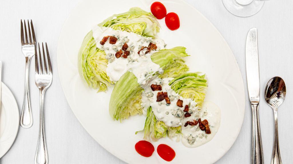 The Wedge · Wedges of iceberg lettuce with Maytag bleu cheese dressing and crispy smoked applewood bacon lardons.