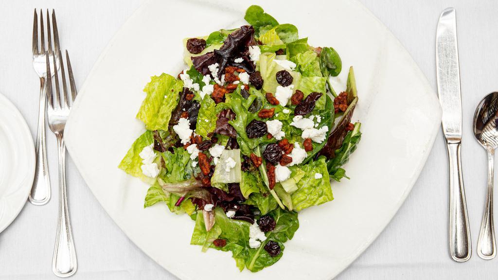 House Salad · Fresh spinach, frisée and baby greens tossed with goat cheese, toasted spiced pecans and dried cherries in a white balsamic vinaigrette.