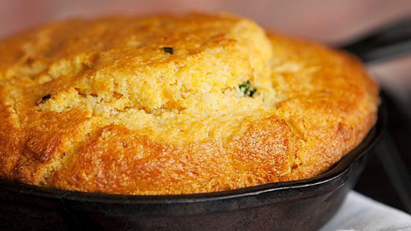 Iron Skillet Cornbread · Six (6) slices of fresh cornbread baked with buttermilk, creamed corn, jalapeno peppers, and serrano peppers. Served in an iron skillet.