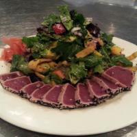 Seared Ahi Tuna Salad · Seared, sesame-crusted ahi tuna accompanied by fresh field greens, mango, avocado, red peppe...