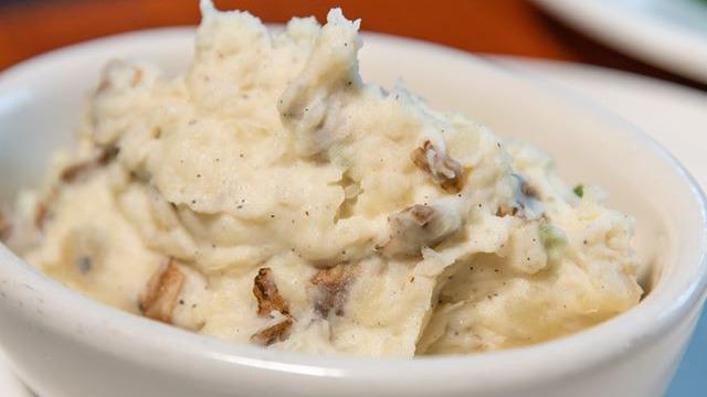 Mashed Potatoes · Idaho potatoes tossed with sour cream, butter, kosher salt, fresh-cracked black pepper, and green onions.