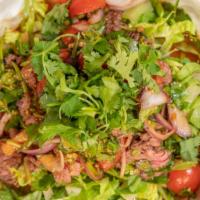 Grilled Beef Salad · Spicy. House marinated slices of grilled flank steak, red onions, scallions and cilantro, to...
