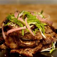 Short Ribs · Grilled marinated bone-in beef Korean style. Topped with scallions and toasted sesame seeds....