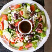 Large Greek Salad · Kalamata olives, banana peppers, tomato, onion, feta, english cukes, and bell pepper.