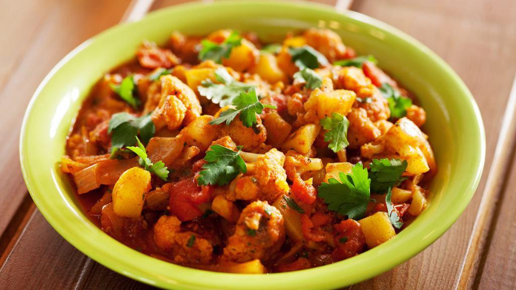 Aloo Gobi · Fresh cauliflower and sautéed potatoes cooked dry with spice and tomato.