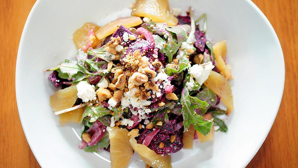 Beet Salad · Roasted red and golden beets, pickled red onion, arugula, mild goat cheese, toasted hazelnuts, hazelnut vinaigrette