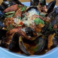 Chorizo Mussels · Steamed Prince Edward Island mussels, chistorria sausage, tomato, leeks, white wine, parsley