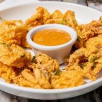 Hand Battered Calamari · lightly breaded calamari fried until golden brown and finished with cracked pepper. served w...