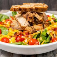Crispy Jerk Chicken Blt Salad · Mixed greens tossed with Chicken George's legendary jerk non-gmo chicken sliced and tossed w...