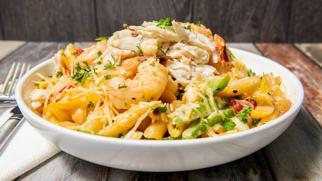Rude Boy Pasta · Boasting the classical island flavors of sautéed peppers and onions in a mild Caribbean-spiced creamy sauce over penne pasta topped with mixed cheeses.