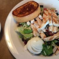 Grilled Chicken Salad · Tossed greens, hard-boiled eggs, sliced olives, tomatoes and Monterey Jack cheese topped wit...