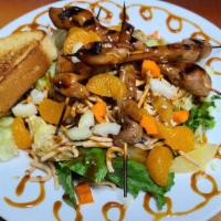 Asian Chicken Salad · Thai chicken, mandarin oranges, carrots, celery, rice noodles on a bed of red cabbage and ro...