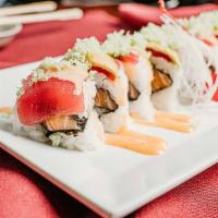 Lovers Roll · Spicy salmon inside and sliced tuna avocado on top with tempura flakes. Raw fish.
