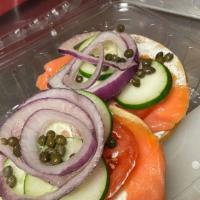 Lox And Bagel Sandwich · Tomatoes, onions, capers, cream cheese, lox, and cucumbers.